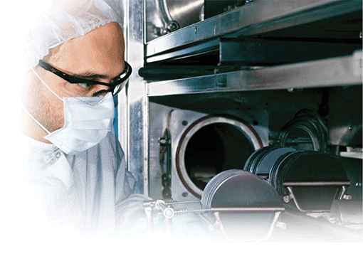 scientist inspecting wafers